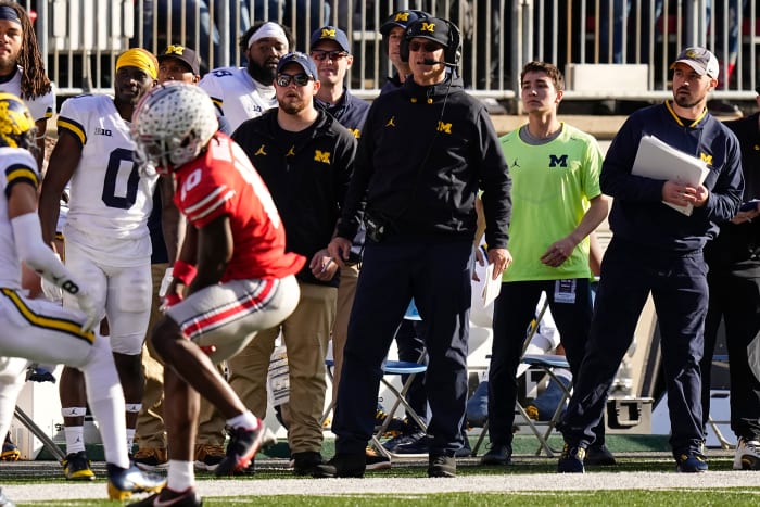 Michigan Wolverines head coach Jim Harbaugh watches from the sideline beside off-field analyst Connor Stalions, right, during the NCAA football game against the Ohio State Buckeyes at Ohio Stadium